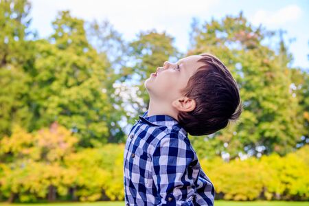 Portrait of a boy in a shirt on the street. Beautiful boy. Little boy. Walk. A child's smile. Slavic appearanceの写真素材