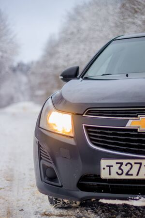 Car in winter in nature outside the city. Snow picture. Snow on the road. Winter road. The white trees. Black car. The car on the road. Journey. 26 December 2018のeditorial素材