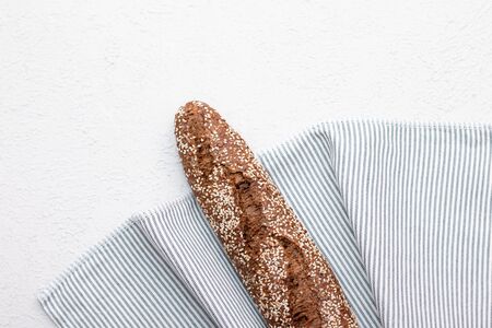 Black bread on a light background with space for text . Homemade fresh pastries. Bread with seeds. Place for the text. Bakery menu design.の写真素材