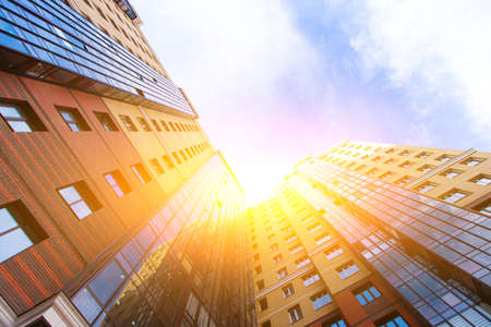 Windows of a high multi-storey residential building. Residential apartment building. Blue sky. Place under the text. Structure. An article about housing. Russia, St. Petersburg April 21, 2020のeditorial素材