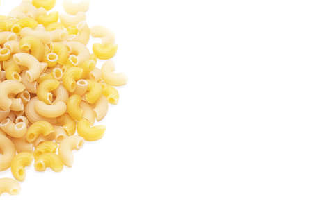 Macaroni horns isolated on a white background. Durum macaroni. Copy space. Article about pasta. Cooking pasta dishesの写真素材