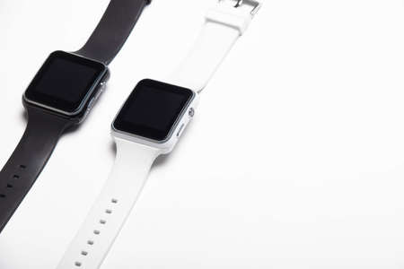 Electronic wrist watch on a white background . White and black wrist watches. Womens and mens...