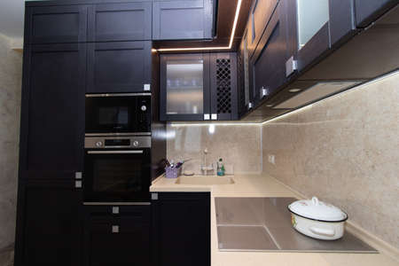 Modern kitchen made of solid black. The kitchen is of solid oak. details. Modern kitchen furniture filling. Furniture to order. The design of the apartment. The black kitchen. Furniture. Russia, Saint Petersburg, new building, April 15, 2020のeditorial素材