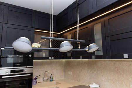 Modern kitchen made of solid black. The kitchen is of solid oak. details. Modern kitchen furniture filling. Furniture to order. The design of the apartment. The black kitchen. Furniture. Russia, Saint Petersburg, new building, April 15, 2020のeditorial素材