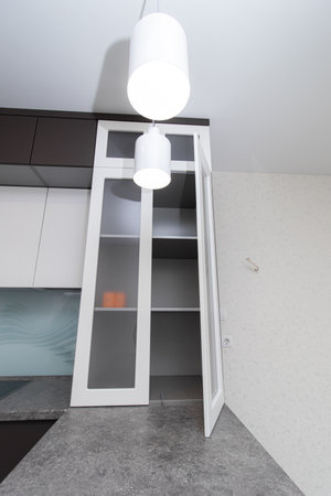 Modern black and white kitchen. The kitchen is in two colors with built-in handles. Opening doors from pressing. Interior. Russia, St. Petersburg April 21, 2020のeditorial素材