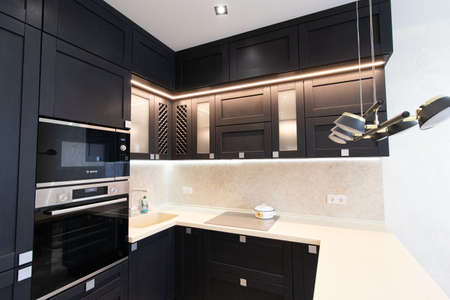 Modern kitchen made of solid black. The kitchen is of solid oak. details. Modern kitchen furniture filling. Furniture to order. The design of the apartment. The black kitchen. Furniture. Russia, Saint Petersburg, new building, April 15, 2020のeditorial素材