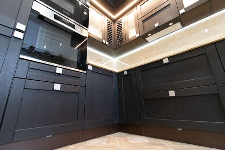 Modern kitchen made of solid black. The kitchen is of solid oak. details. Modern kitchen furniture filling. Furniture to order. The design of the apartment. The black kitchen. Furniture. Russia, Saint Petersburg, new building, April 15, 2020のeditorial素材