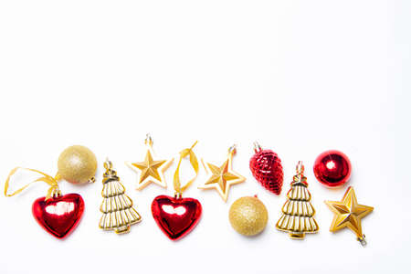 Christmas balls on a white background. The layout of the Christmas toys top view. Copy space. decor. Red and gold toys. White backgroundの写真素材
