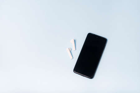 Copy space phone and wireless headphones. Modern design. Electronics. Select headphones for your...