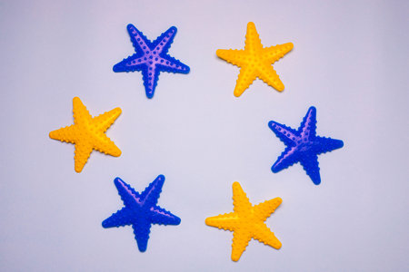 Toys on the bathroom wall. Toys in the bathroom. Toys with suction cups. Blue background. Copy space. The article is about games in the bath. Children's leisure. Washing children. Colored Starfishの写真素材