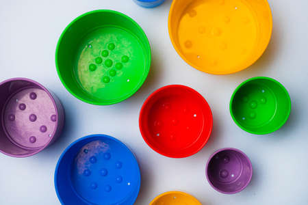 Children's game tower color. Children's pyramid. The game is collect by size. Multi colored pyramid. Water games. The development of the child. Copy space. Blue backgroundの写真素材