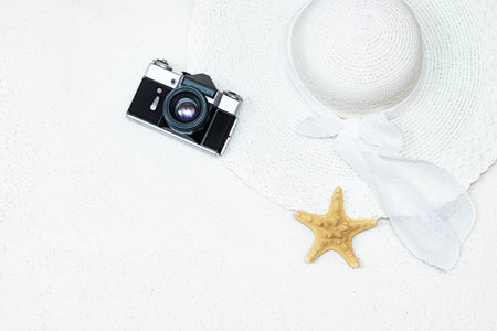 The vacation layout. Vacation layout on a white background. A sun hat. Protective equipment. Copy space. Space for the text. Article about vacation. Article about vacation insurance. White background. Starfishの写真素材