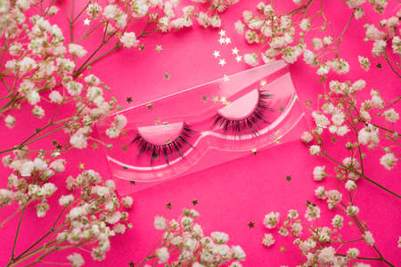 False eyelashes. False eyelashes on a pink background. Layout of the beauty industry. Beauty and...