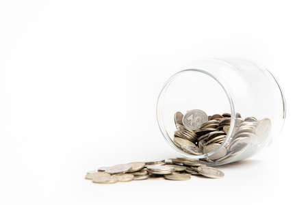 The coins in the bank are isolated on a white