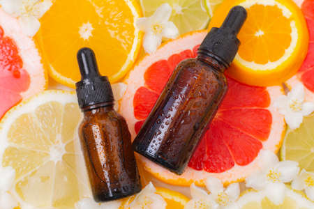 Cosmetic oil and citrus fruits . The concept of a bottle of cosmetic oil without a name....