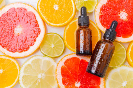 Cosmetic oil and citrus fruits . The concept of a bottle of cosmetic oil without a name. Cosmetology. Skin care. Spa. High quality photoの写真素材
