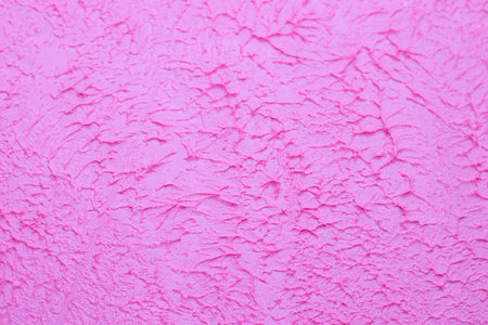 Pink background texture of putty. Decorative wall decoration. Pink wall. Texture with your own...