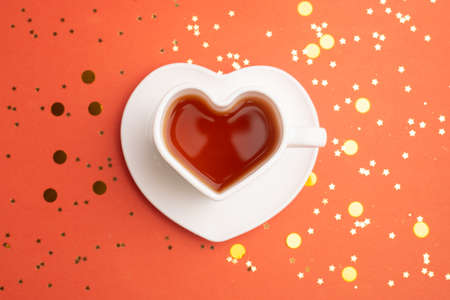 New Year s tea on a red background . Glitter and red background. Holiday. Holiday decorations.の写真素材