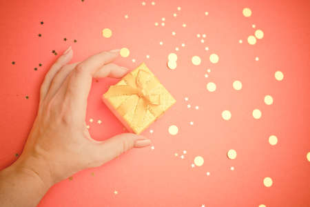 A New Year 's gift in a woman' s hand. A Christmas present. Copy space. An article about choosing a...
