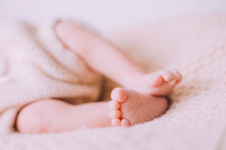 Legs of a newborn baby lifestyle . A small child. An article about newborns.