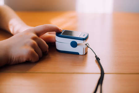 Pulse measurement on the finger lifestyle. An article about medical devices. Pulse measurement at home. Measurement of air saturation in the blood. Saturation check.の写真素材