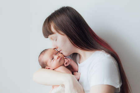 Mom holds the baby in her arms lifestyle. Mother's love for her son. A newborn baby. mother and child relationship.の写真素材