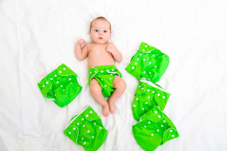 Reusable diaper on the baby copy space . An article about reusable diapers. Saving on diapers. Concern for the environment. Eco-products. Breathable diapers with buttons. High quality photoの写真素材