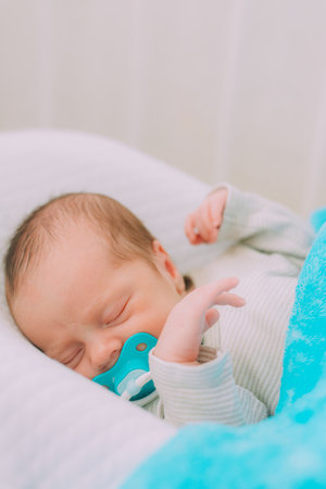 The baby is lying in a cocoon of copy space. The baby is 0-3 months old. A contented infant. An article about choosing a cocoon for newborns. An article about the benefits of cocoon. An article about colic.の写真素材