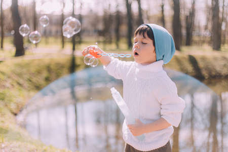 The boy blows soap bubbles lifestyle. children's entertainment. children's portrait. Article about...
