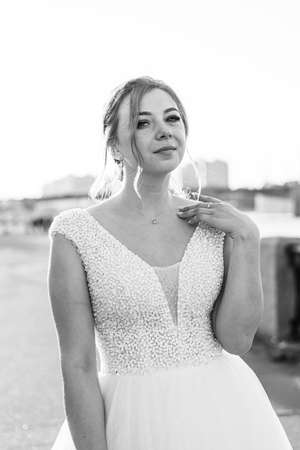 Portrait of the bride in the evening light. wedding article. wedding season. Choosing a wedding dress. Make-up and hairstyle for the holiday. happy bride.の写真素材