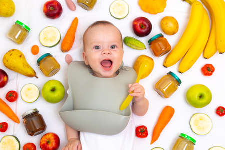 Puree for baby food with vegetables and fruits. Selective focus. nutrition. The first complementary feeding of the child. A happy child. A well-fed childの写真素材