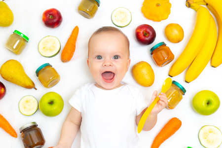 Puree for baby food with vegetables and fruits. Selective focus. nutrition. The first complementary feeding of the child. A happy child. A well-fed childの写真素材