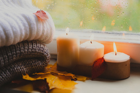 A burning candle on the window is autumn . the comfort of home . autumn comfort . autumn mood. The chondra .の写真素材