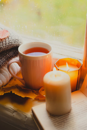 A burning candle on the window is autumn . the comfort of home . autumn comfort . autumn mood. The chondra .の写真素材