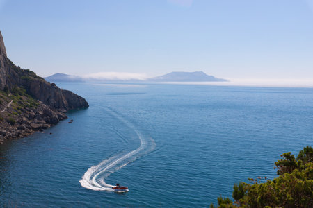 Sea view with a boat and mountains . Summer view . Article about travel