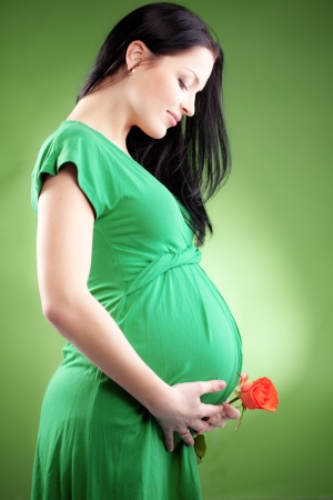 Portrait of pregnant woman with roseの写真素材