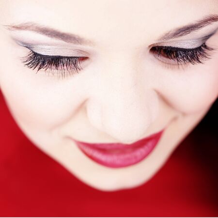 Studio closeup portrait of pretty brunette with bright make-upの写真素材