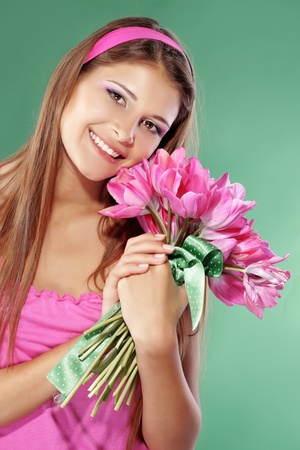 Beautiful girl with bunch of spring flowersの写真素材