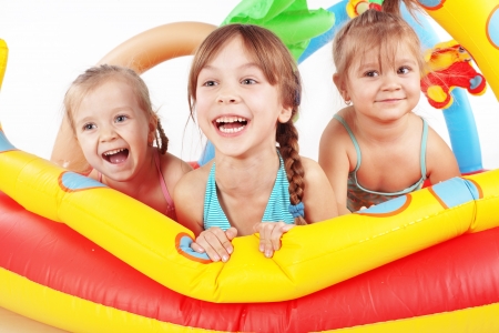 Children playing in swimming pool studio shotの写真素材