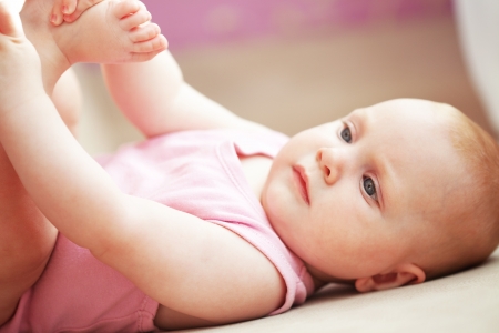 Picture of a baby lying in bedの写真素材