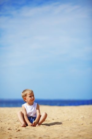 Portrait of a child at the beach aloneの写真素材