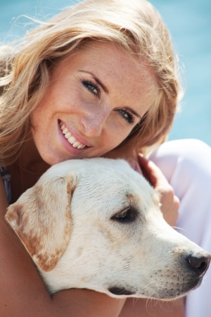 Portrait of young girl hugging her dogの写真素材