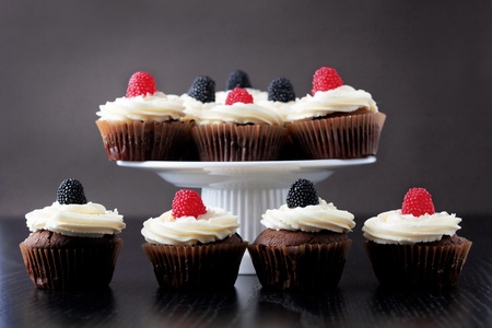 Group of cupcakes with blackberry and raspberryの写真素材