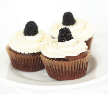 Group of cupcakes with blackberry and raspberryの写真素材
