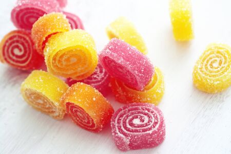 Sweet sugar candies on white wooden backgroundの写真素材