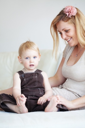 Mother playing with her toddler child at homeの写真素材