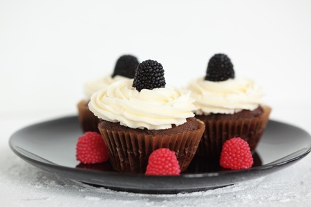 Group of cupcakes with blackberry and raspberryの写真素材