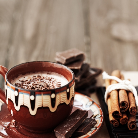 Cup of hot chocolate cocoa with cinnamon sticks on vintage wooden background, selective focusの写真素材