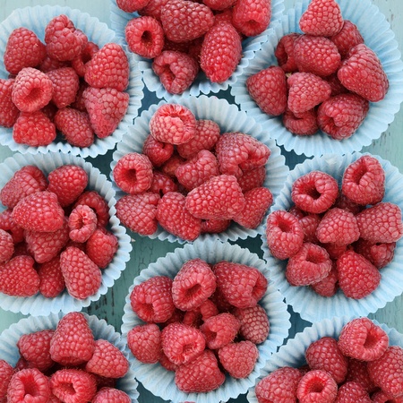 Ripe raspberries on a wooden tableの写真素材