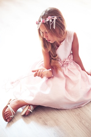 Beautiful little girl wearing fairy costume with magic wandの写真素材